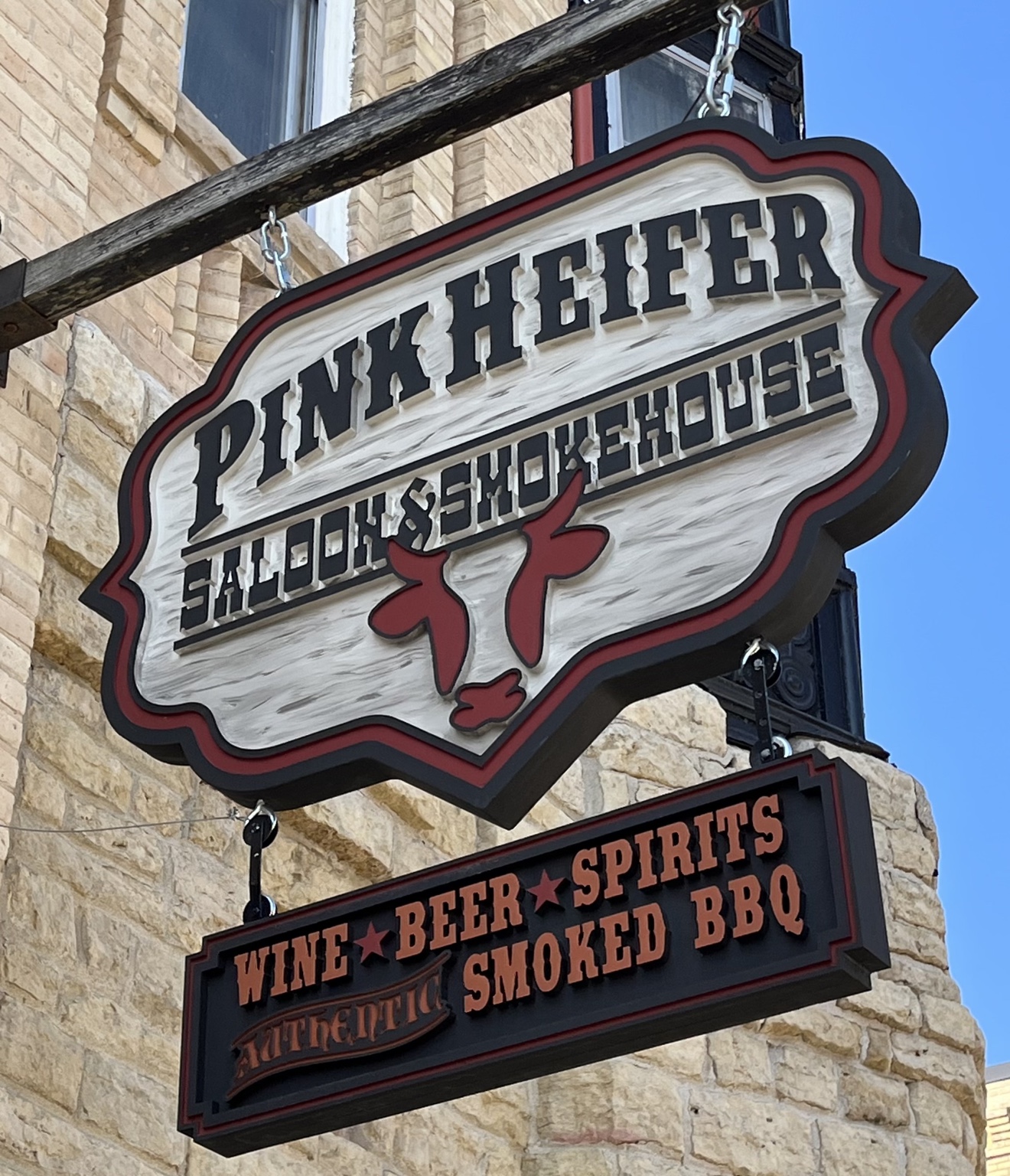 The Pink Heifer Saloon and Smokehouse sign outside the Monticello House